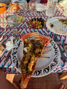 a slice of pizza on a plate on a table at Sidi kawiki azro plage in Essaouira