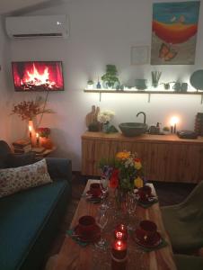 a living room with a couch and a table with flowers at Heavens Embrace - ateliér pri Slovenskom raji in Smižany