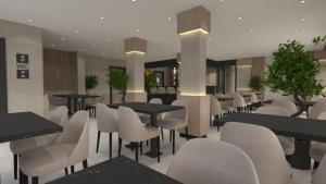a restaurant with tables and white chairs and tables and chairs at La Vita Es Bella in Antalya