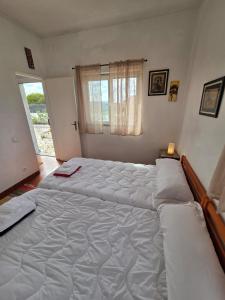 a bedroom with two large beds in it at Casita do avô in Carvoeira