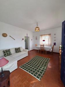 a living room with a couch and a table at Casita do avô in Carvoeira