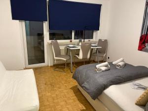 a bedroom with a bed and a table and chairs at Steffies Appartement Four in Niedernhausen