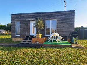 a tiny house with a statue in front of it at Domeček Sára in Mohelnice