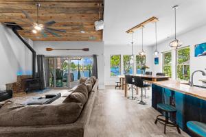 a living room and kitchen with couches and a bar at Nancy Key w/Pool, Wine Cave, Optional Boat Rental in Denver