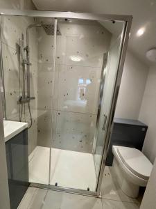 a glass shower in a bathroom with a toilet at Bedford Guesthouse in Liverpool +39 photos