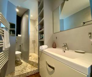 a white bathroom with a sink and a toilet at The Montpellier Escape-Duplex featuring a terraceconditioning in Montpellier