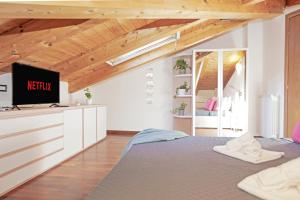 a bedroom with a bed with a tv on it at Prestige Villa - 5 min from the train station - Garden and private Parking in Lunense