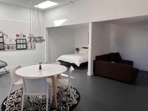 a living room with a table and a bed at Atlantic Oasis in Halifax
