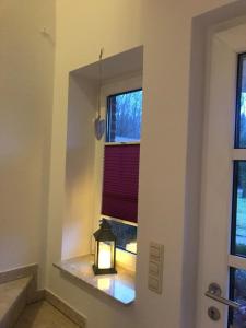 a lantern sitting on a window sill in a room at Schöne Auszeit RE14 in Sögel