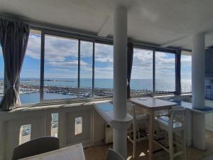a room with a table and a view of the ocean at L'Eternel Estivant in Sète +20 photos