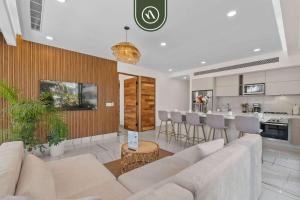 a living room with a couch and a kitchen at Luxury 2 BR Condo with Dream Pools - Beach - Art in Bucerías