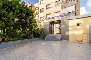 a building with a staircase in front of a building at APT-Cinema Pool-Free Parking-Gym-Netflix in El Jadida