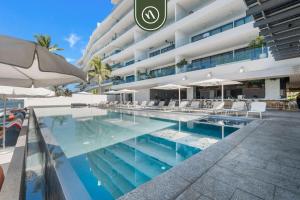a swimming pool in front of a building at Luxury 2 BR Condo with Dream Pools - Beach - Art in Bucerías