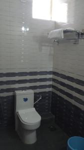Un baño con un inodoro blanco en una habitación. en Calangute Pristine Guest House, en Calangute