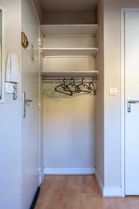 a walk in closet with white walls and a door at Le Grenier - Blois hyper centre in Blois