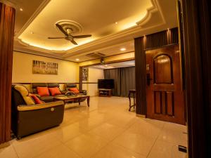 a living room with a couch and a ceiling fan at Cozy-SJ-Family Holidays-Work-BBQ-Tea ceremony-Engagement in Subang Jaya