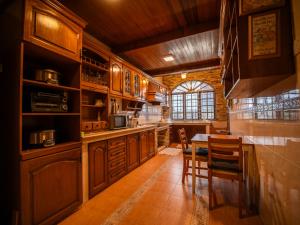 a kitchen with wooden cabinets and a table and chairs at Cozy-SJ-Family Holidays-Work-BBQ-Tea ceremony-Engagement in Subang Jaya