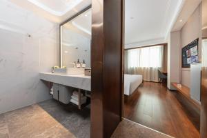 a bathroom with a sink and a large mirror at Guangzhou CHILLNOW Hotel in Guangzhou +21 photos