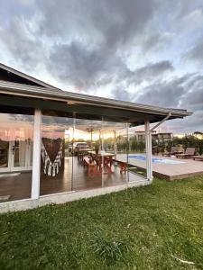 a large house with a deck and a pool at Cabana Guimarães in Rancho Queimado