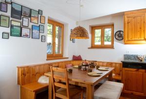 a dining room with a wooden table and chairs at Charming ski-in ski-out mountain hut in Lenzerheide