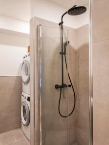 a shower in a bathroom with a washing machine at Luxury apartments in the city center - Berlin in Fellbach +89 photos