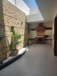 a hallway with a brick wall and potted plants at new apartment in Cochabamba