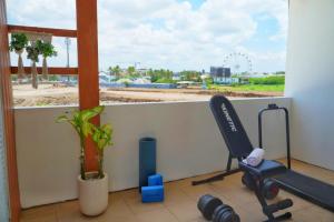 チャングーにある5BR Private Pool Villa - 1 min Beach - Daily Staff, Private Pool, Gym & Gamesの窓とトレッドミルと植物のあるフィットネスルーム