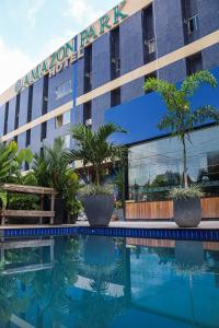 a hotel with a swimming pool in front of a building at Amazon Park Hotel in Belém