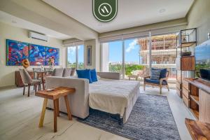 a living room with a bed and a dining room at New 2 BR Condo One Street From Beach - Pool - Gym in Nuevo Nayarit