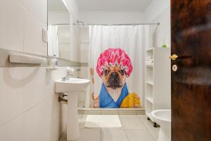 a dog in a shower curtain in a bathroom at Departamentos Brown in San Rafael