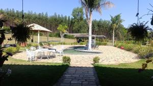 a patio with a table and a gazebo at Chácara Recanto Dona Celeida in Goiás