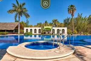 een resort met zwembad en palmbomen bij Amazing 2BR Condo in Nuevo Vallarta - Pool - King in Nuevo Nayarit