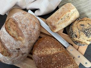 a bunch of loaves of bread on a cutting board at De Hoffstee in Minnertsga