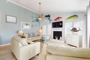 a living room with a couch and a fireplace at Seas the Day in Port Aransas