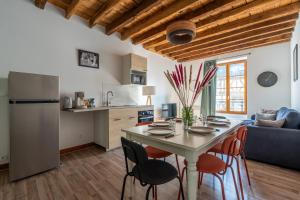 a kitchen and living room with a table and chairs at La Grande Vadrouille - 8 personnes en hyper centre in Blois