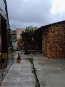 cortile di un edificio con muro in pietra di chalé alpino a Saquarema