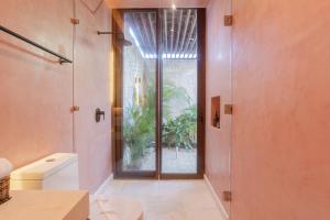 a bathroom with a shower and a glass door at Entorno Tulum - Luxury Villas in Tulum +88 photos