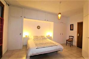 a bedroom with a bed and a chair in it at Gîte et chambre d'hôtes LE MERCOIRE, piscine chauffée et jacuzzi in Aubenas +41 photos