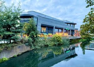 a building next to a body of water at Bright & Lovely Apartment in Chelmsford in Chelmsford