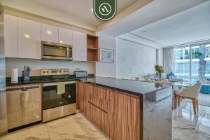 a kitchen with a counter and a stove top oven at 2BR Condo with Private Balcony - Padel Court in Nuevo Nayarit