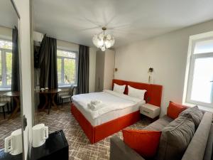 a hotel room with a bed and a couch at Naya Hotel in Almaty