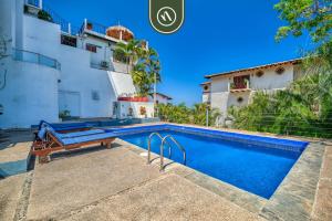 a villa with a swimming pool in a resort at Corner 2 BR Condo - Spectacular Oceanview Sunsets in Puerto Vallarta
