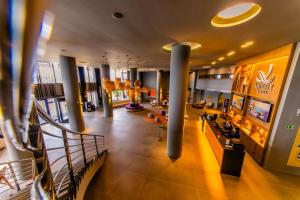 a lobby of a building with columns and a staircase at Quality Hotel Aracaju in Aracaju