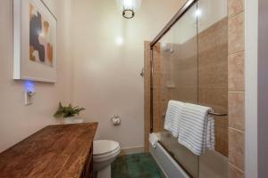 a bathroom with a toilet and a glass shower at Roe Parker House in Hood River