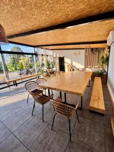 a wooden table and chairs on a patio at Zeltāres in Jelgava