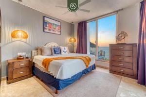 a bedroom with a bed and a large window at Corner 2 BR Condo - Spectacular Oceanview Sunsets in Puerto Vallarta +38 photos