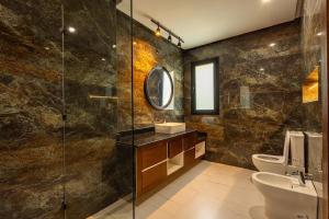 a bathroom with a sink and a glass shower at Villa Indigo in Rabat +14 photos