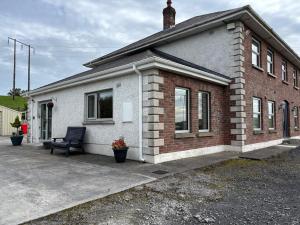 a brick house with a bench in front of it at apartment cavan in Cavan