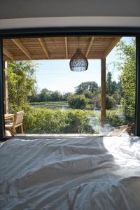 Un pat sau paturi într-o cameră la EXCLUSIVITE Lodge luxe avec bain nordique au bord du canal à 1h15 de Paris +26 fotografii