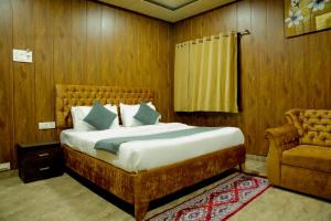 a bedroom with a large bed and a chair at Rio Royale in Bhimashankar +46 photos